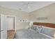 Bedroom with coastal décor, wicker headboard, and a ceiling fan above the bed at 10181 Colubrina Dr, Venice, FL 34293