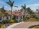 Beautiful clubhouse featuring a tile roof, well-manicured landscaping, and a welcoming entrance at 10181 Colubrina Dr, Venice, FL 34293