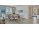 Dining area with seating for six, chandelier, and large windows at 10181 Colubrina Dr, Venice, FL 34293