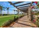 Picturesque walkway lined with lush landscaping, flowers, and clear views of the golf course at 10181 Colubrina Dr, Venice, FL 34293