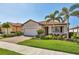 Charming single Gathering home with a well manicured lawn, paver driveway, and a tile roof at 10181 Colubrina Dr, Venice, FL 34293