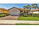 Charming single Gathering home with a well manicured lawn, paver driveway, and a tile roof at 10181 Colubrina Dr, Venice, FL 34293