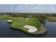 Scenic golf course view with lush green grass, sand traps, and a beautiful water hazard at 10181 Colubrina Dr, Venice, FL 34293