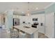 Beautiful kitchen with a large island, pendant lighting, and white cabinetry at 10181 Colubrina Dr, Venice, FL 34293