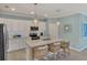 Gorgeous kitchen with quartz countertops, stainless appliances, and pendant lights at 10181 Colubrina Dr, Venice, FL 34293