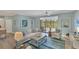 Bright living room with comfortable seating, ceiling fan, and sliding glass doors to the pool at 10181 Colubrina Dr, Venice, FL 34293