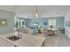Open concept living space with dining area, neutral color palette, and ample lighting at 10181 Colubrina Dr, Venice, FL 34293