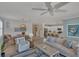 Coastal-style living room with light wood floors and beachy decor at 10181 Colubrina Dr, Venice, FL 34293