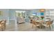 Open concept living room and dining area with access to the lanai and pool at 10181 Colubrina Dr, Venice, FL 34293