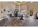 Spacious lobby area featuring tile floors, high ceilings, seating, and access to Palm Dining at 10181 Colubrina Dr, Venice, FL 34293