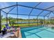 Inviting screened-in pool with integrated spa and beautiful lake views at 10181 Colubrina Dr, Venice, FL 34293