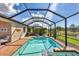 Screened-in pool and spa, brick pool deck and adjacent outdoor seating at 10181 Colubrina Dr, Venice, FL 34293