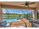Relaxing screened-in pool area with brick patio, pool, spa, and seating overlooking the lake at 10181 Colubrina Dr, Venice, FL 34293