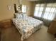 Charming bedroom featuring a seahorse patterned quilt, a mirrored accent and bright natural light at 105 Lakeview Dr, North Port, FL 34287