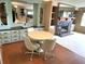 Cozy dining area featuring a round table with chairs, built-in cabinets, and a fireplace at 105 Lakeview Dr, North Port, FL 34287