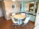 Bright dining area with a round table, chairs, and built-in cabinets with mirrors at 105 Lakeview Dr, North Port, FL 34287