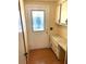 Entryway features a cream door with decorative glass, built-in desk, wood flooring, and neutral walls at 105 Lakeview Dr, North Port, FL 34287
