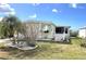 Exterior side view featuring mature landscaping, privacy features, and a well maintained lawn at 105 Lakeview Dr, North Port, FL 34287
