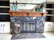 Stone fireplace with a wooden mantel flanked by built-in shelves and cabinets at 105 Lakeview Dr, North Port, FL 34287