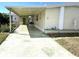 Charming single Gathering home featuring a welcoming front yard, palm trees, and covered parking at 105 Lakeview Dr, North Port, FL 34287