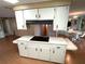Kitchen island featuring cooktop with hood and storage, in an open floor plan near the dining area at 105 Lakeview Dr, North Port, FL 34287