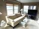 Bright living room with a sofa, glass coffee table, and large windows overlooking water at 105 Lakeview Dr, North Port, FL 34287
