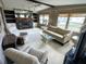 Spacious living room with a fireplace, sofa, chairs, and plenty of natural light at 105 Lakeview Dr, North Port, FL 34287