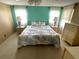 Inviting main bedroom with a coastal-themed bed, ceiling fan, and natural light at 105 Lakeview Dr, North Port, FL 34287