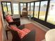 Bright sun room with large windows offers serene water views and comfortable seating arrangements at 105 Lakeview Dr, North Port, FL 34287