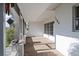 View of the shaded front porch entrance featuring painted columns and number on wall at 1160 Linden Rd, Venice, FL 34293