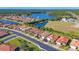 Aerial view of the community showcasing single-story homes, lush landscaping, and a beautiful lake at 11666 Parrotfish St, Venice, FL 34292