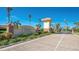 Welcoming entrance to Caribbean Village with brick-paved roads, lush landscaping, and a charming community sign at 11666 Parrotfish St, Venice, FL 34292