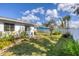 Lush backyard featuring mature landscaping, a rock garden, and a well-maintained lawn at 1181 Southland Rd, Venice, FL 34293