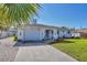 Charming single-story home with a well-kept lawn, attached garage, and nautical decor at 1181 Southland Rd, Venice, FL 34293