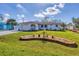 Well-maintained single-story home features a lush lawn, an attached garage, and charming nautical accents at 1181 Southland Rd, Venice, FL 34293