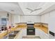 Bright kitchen featuring white cabinets, a ceiling fan, and modern appliances at 1181 Southland Rd, Venice, FL 34293