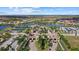 Aerial view of a grand community entrance, showcasing lush landscaping, scenic lakes, and manicured streets at 12279 Canavese Ln, Venice, FL 34293