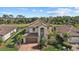 Charming home with tile roof and tropical landscaping overlooking a serene lake at 12279 Canavese Ln, Venice, FL 34293