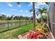 Backyard features colorful Adirondack chairs overlooking a lake and lush vegetation at 12279 Canavese Ln, Venice, FL 34293