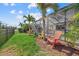 Landscaped backyard with Adirondack chairs overlooking the pool and lush vegetation at 12279 Canavese Ln, Venice, FL 34293