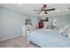 Bright bedroom with a ceiling fan, dresser with mirror, and view to the bathroom at 12279 Canavese Ln, Venice, FL 34293