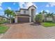 Gorgeous two-story home featuring a barrel tile roof and a brick paver driveway at 12279 Canavese Ln, Venice, FL 34293