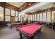 Recreational game room features a red felt pool table and a traditional dart board setup at 12279 Canavese Ln, Venice, FL 34293