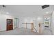 View of the hallway and staircase with carpet flooring and white banisters at 12279 Canavese Ln, Venice, FL 34293
