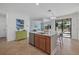 Open kitchen with a center island, stainless appliances, and seamless access to the outdoor patio at 12279 Canavese Ln, Venice, FL 34293