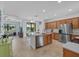 Open kitchen with stainless steel appliances, central island with counter seating and ample cabinet space at 12279 Canavese Ln, Venice, FL 34293