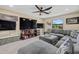 Large, bright living room with large sectional sofa, mounted television, and outdoor view at 12279 Canavese Ln, Venice, FL 34293