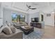 Comfortable living room with neutral tones, large windows, and a stylish coffee table at 12279 Canavese Ln, Venice, FL 34293