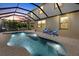 Inviting screened-in pool area with a spa and comfortable seating, perfect for relaxation at 12279 Canavese Ln, Venice, FL 34293