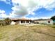 Exterior view of a house showing the spacious backyard, including a shed and a covered patio at 12321 Alta Mira St, North Port, FL 34287